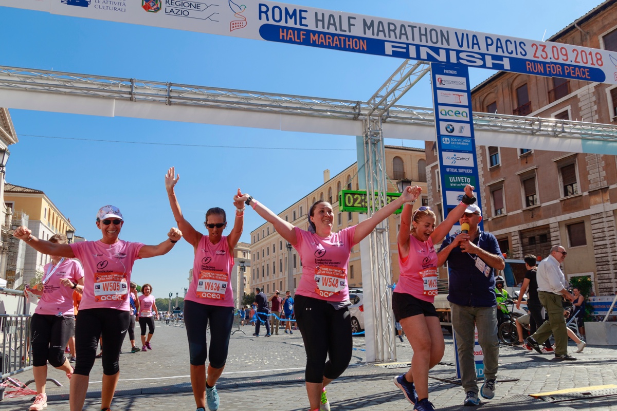 women in pink running a marathon